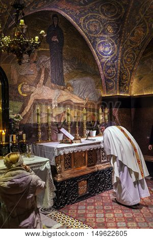 Jerusalem, Israel - February 22, 2013: Catholic Priest Praying  In Temple Of The Holy Sepulchre