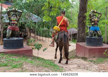 Chiang Rai, Thailand - May 21, 2016: Buddhist Monk Riding A Horse In Golden Horse Temple (wat Phra A