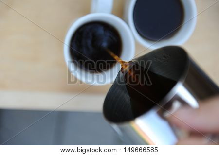 Man making fresh aeropress coffee in nature