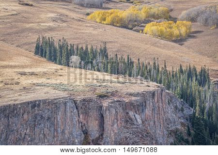 sandstone cliff and aspen grove in fall colors - overlook of Deep Creek Canyon near Dotsero in Rocky Mountains, Colorado