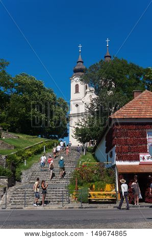TIHANY, HUNGARY-July 30. 2016: Tourists walking in front of Tihany village's center with the Benedictine abbey .Tihany is one of the best tourist destination of Lake Balaton