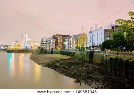 Riverside buildings at night time along the River Thames