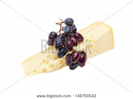 Piece of a Swiss-type cheese and cluster of a blue table grapes on a light background