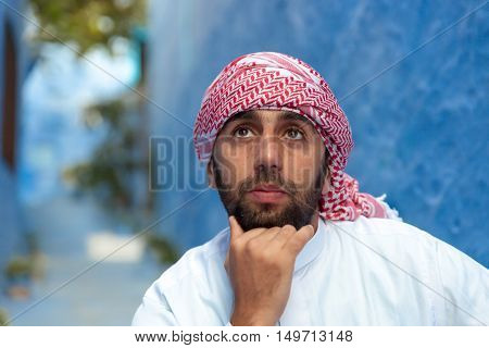 Young smiling handsome arabic man wearing traditional clothes