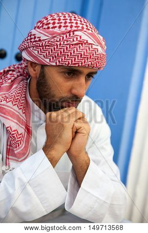 Portrait of young handsome arabic man wearing traditional clothes