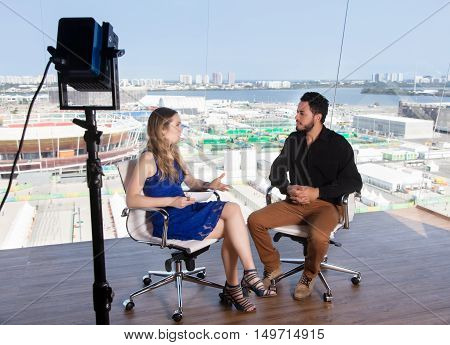Female presenter asking a famous celebrity at tv studio