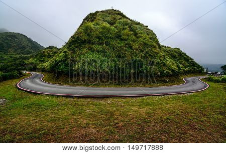 Potentially dangerous hairpin curve on a mountain road along the coast of Jiufen, Taiwan