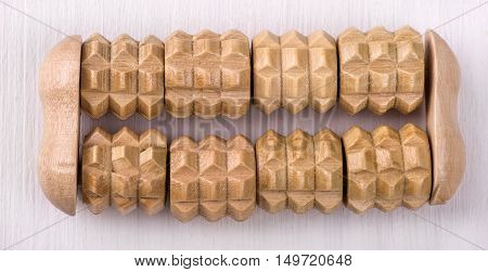 brown wooden bath massager on the white wooden table