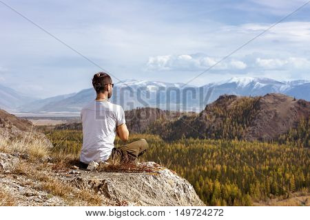 Man meditating on the Altay mountains background