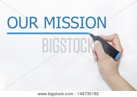 Hand writing our mission with marker on transparent wipe board.