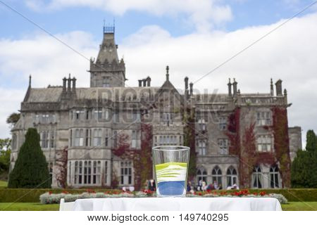 glass of mixed colour sands after a unity wedding celebration in front of adare manor