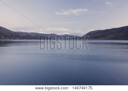 Snowcapped mountains by the sea at Ullapool Scotland