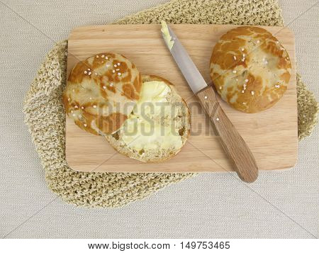 Homemade lye roll cut in half and buttered