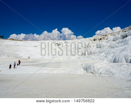 PAMUKKALE DENIZLI TURKEY- SEPTEMBER 14 2016: Pamukkale meaning "cotton castle" in Turkish is a natural site in Denizli Province in southwestern Turkey. The city contains hot springs and travertines.