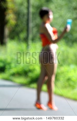 Abstract high key blurred image of young girl making selfie.  Summerday  in germany. Unrecognizable face.