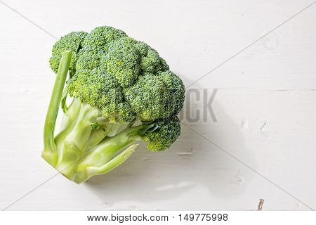 Fresh broccoli vegetarian cooking on white wooden background. Copy space.