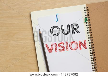 Text our vision on white paper and pencil / business concept