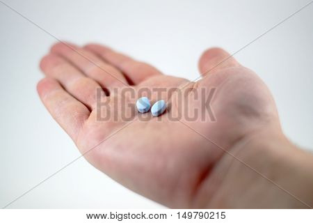 Male Hand With Blue Pills