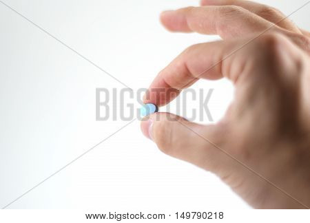 Male Hand With Blue Pills