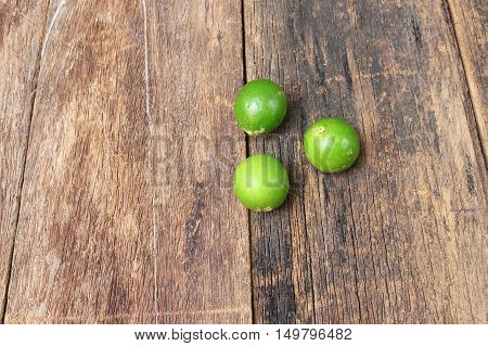 lemon with green on the wooden table top view