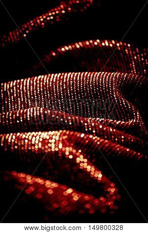 draped lurex fabric - warm red orange color space - dark background