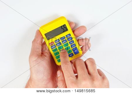 Hands calculate using a digital calculator on a white background