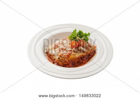 Front view of Traditional style Italian cuisine beef lasagna garnished with parmesan chesse parsley and tomatoes in ceramic dish isolated on white background