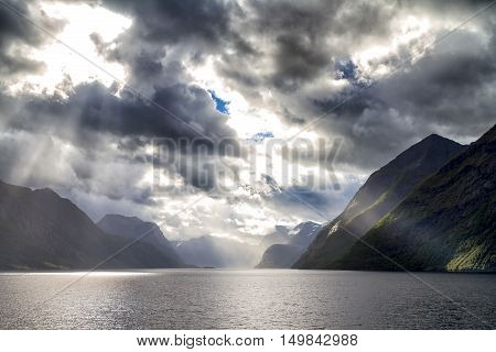 Sunbeam at the dramatic Hjorundfjord Fjordland, Norway