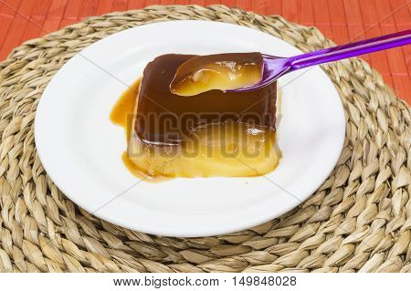 Egg yolk cake and cream served on a plate