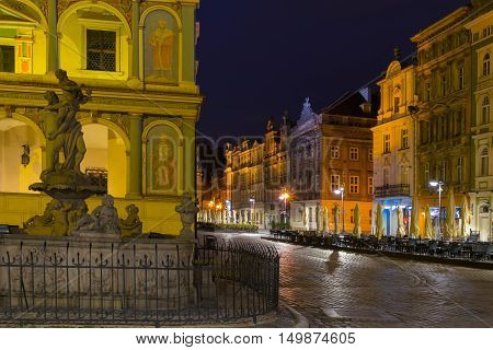 Poznan Poland - September 30 2016: Night photo of Poznan Old Town with Prozerpin's fountain beautifully decorated facade of the city hall and numerous highlighted townhouses.