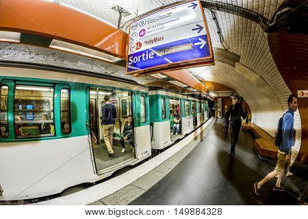 Tourists And Locals On A Subway Train In Paris