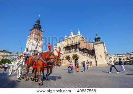 KRAKOW POLAND - September 16 2016: Horse carriages at main square in Krakow in a summer day Poland