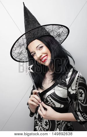 Funny Witch. Young happy woman with canival hat.