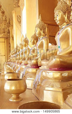 Golden monk's alms bowl and golden buddha statue at Paknam Jolo Temple, Bangkhla, Thailand, October 01, 2016