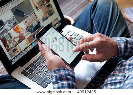 CHIANGMAI, THAILAND -OCT 20, 2016:A man touch on screen new Apple iPhone 6 Plus smartphone device open google application.