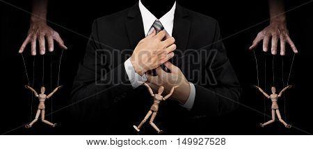 Businessman with wooden figure puppet, concept of business manipulation, panoramic image