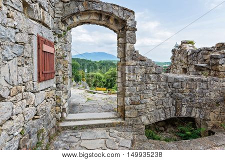 View thru the stone arch, historical building and beautiful landscape
