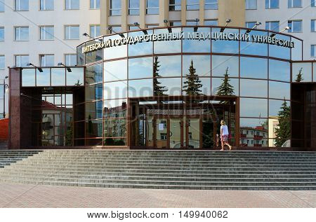 VITEBSK BELARUS - JULY 13 2016: Unidentified woman enters building of Vitebsk State Order of Peoples' Friendship Medical University Vitebsk Belarus