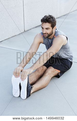 Man warming up before exercise on location