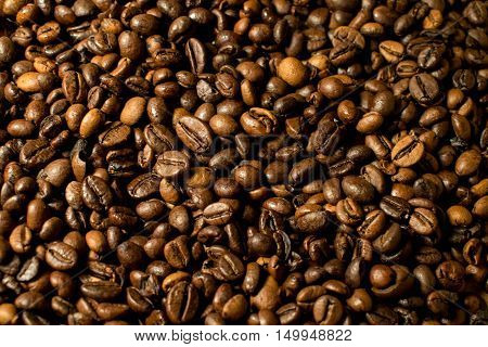 A moltitude of brewed coffee beans as background