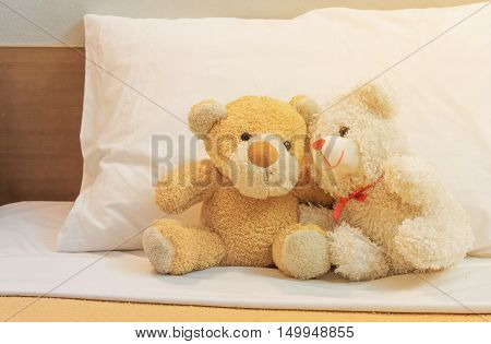 Teddy bears fall in love on a bed of white vintage filters.