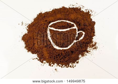 A drawing of a coffee cup in coffee powder