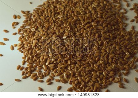 Flax seeds disposed on a white background