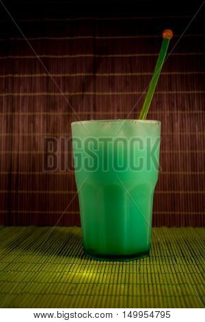 Cocktail green with mint on a bamboo background