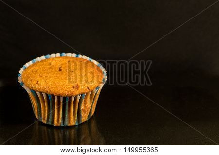 Homemade muffin disposed on a darken background