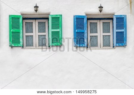 Old blue window and Old green window with white wall
