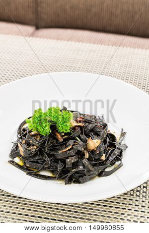 Fresh black aglio olio pasta with garlic and chilli