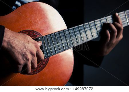 Guitar instrument. Musician or guitarist. Music musical sound. Finger hand on string. Acoustic concert closeup. Player play chord. Wood jazz rock performance. Fretboard.