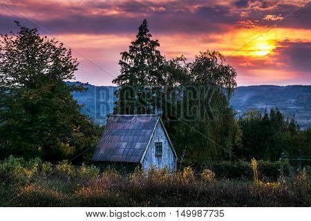 Small hillside cottage at neautiful pieceful sunset