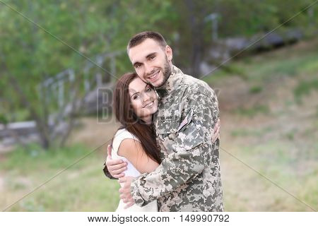Happy US army soldier with wife in park